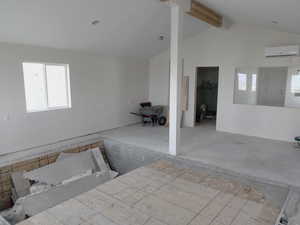 Unfurnished room featuring a wall unit AC