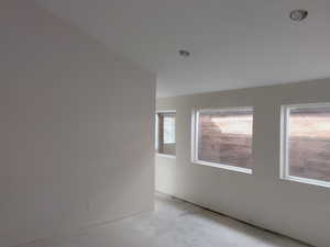 Unfurnished room with concrete flooring