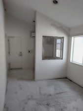 Unfurnished room with concrete floors and a wall unit AC