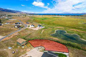 Aerial view of property and surrounding area with mountains