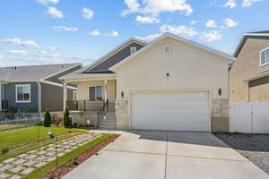 View of front of home featuring stone siding, stucco siding, a porch, and concrete driveway