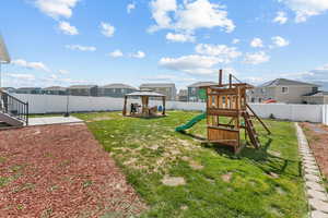 View of yard featuring a gazebo, a residential view, a playground, and a patio