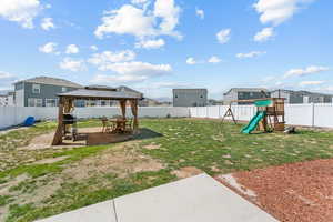 View of yard featuring a playground, a residential view, a gazebo, and a patio area