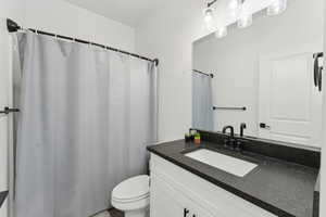 Bathroom featuring vanity and toilet