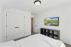 Carpeted bedroom with baseboards and a closet