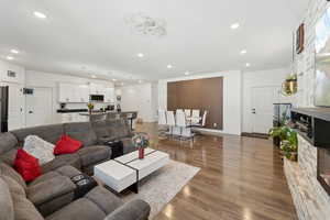 Living area with recessed lighting, wood finished floors, and baseboards