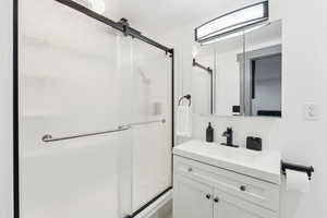 Bathroom with vanity and a shower stall