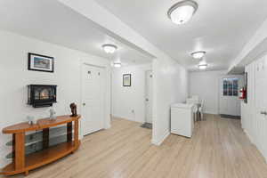Laundry room with light wood-style flooring and baseboards