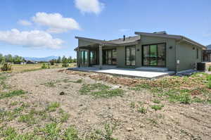 Rear view of house featuring a patio and a mountain view