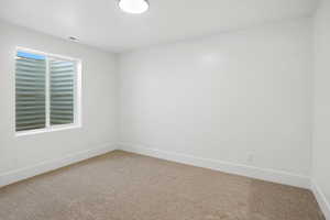 Empty room with light colored carpet