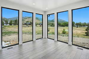 Unfurnished sunroom featuring a mountain view