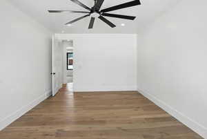 Spare room with ceiling fan, light wood finished floors, and recessed lighting