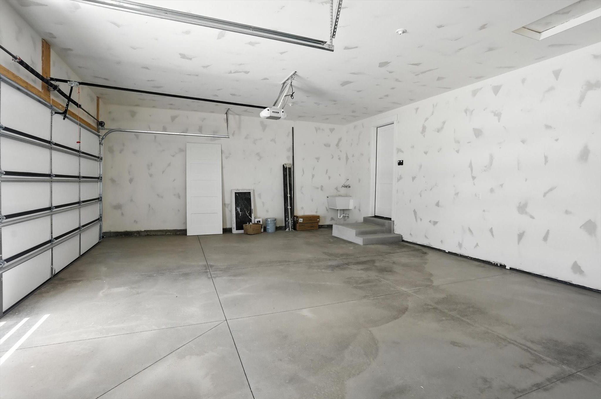 Garage featuring a garage door opener