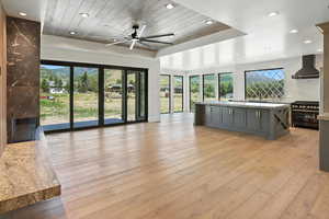 Unfurnished living room featuring wooden ceiling, recessed lighting, ceiling fan, light wood finished floors, and a high end fireplace