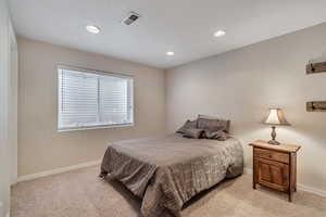 Bedroom with light carpet, baseboards, and recessed lighting