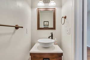 Bathroom with vanity and a chandelier