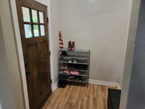 Entryway with wood finished floors and baseboards