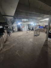 Unfinished basement featuring secured water heater