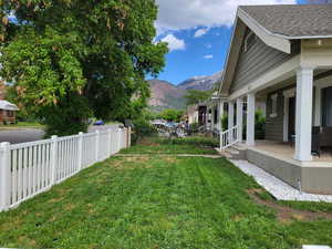 View of yard with a mountain view and a porch