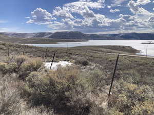View of mountain backdrop featuring a nearby body of water