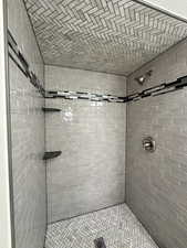 Full bath featuring a tile shower