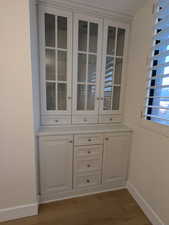 Detailed view of baseboards and wood finished floors