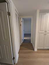 Hallway featuring baseboards and light wood-type flooring
