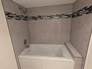 Full bathroom featuring a combined bath / shower with jetted tub