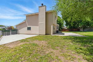 Back of property with a concrete driveway for a RV.