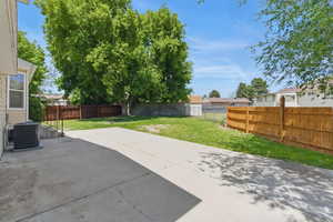 Fully fenced yard with a beautiful shade tree.