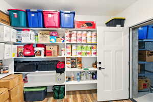 Built in shelving in large storage room with access to cold storage under the porch.