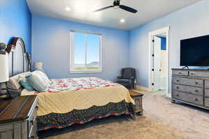 Primary bedroom featuring ensuite bath, baseboards, ceiling fan, and recessed lighting
