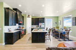 Kitchen with stainless steel appliances, a sink, healthy amount of natural light, light countertops, and recessed lighting