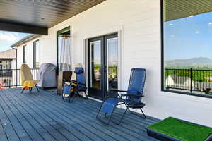 Composit deck with french doors and a mountain view