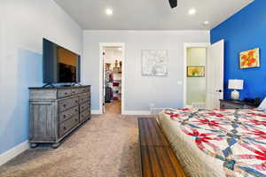Primary bedroom featuring a spacious closet, baseboards, recessed lighting, and ceiling fan