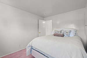 Carpeted bedroom featuring baseboards