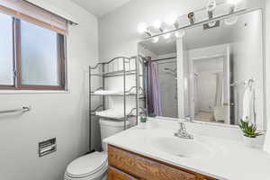 Full bath featuring vanity and curtained shower