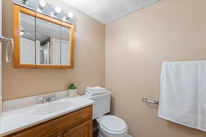 Bathroom featuring vanity and a textured ceiling