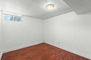 Unfurnished room with dark wood finished floors and baseboards