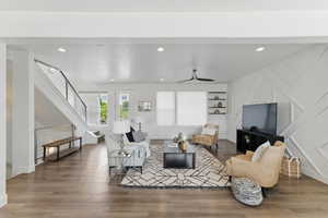 Living area with stairs, wood finished floors, recessed lighting, baseboards, and ceiling fan