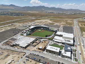 Aerial view of property and surrounding area with a mountain backdrop