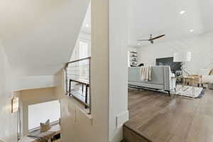 Stairs with a ceiling fan, recessed lighting, and wood finished floors