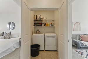 Laundry area with washer and dryer and tile patterned floors