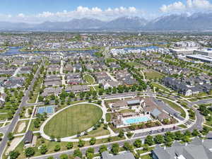Aerial view of property's location featuring a water and mountain view and nearby suburban area