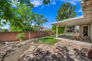 Fenced backyard featuring a patio area