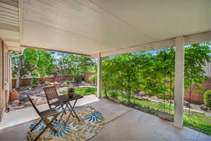 Covered patio with lush greenery