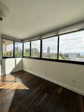 Unfurnished sunroom featuring a city view