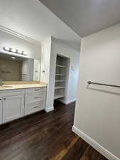 Bathroom with vanity, built in features, wood finished floors, crown molding, and a shower