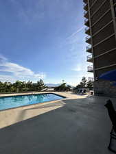 Community pool featuring a patio area and a mountain view