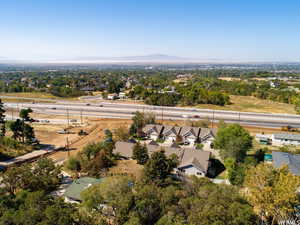 Aerial view of residential area featuring a major roadway and a mountain backdrop